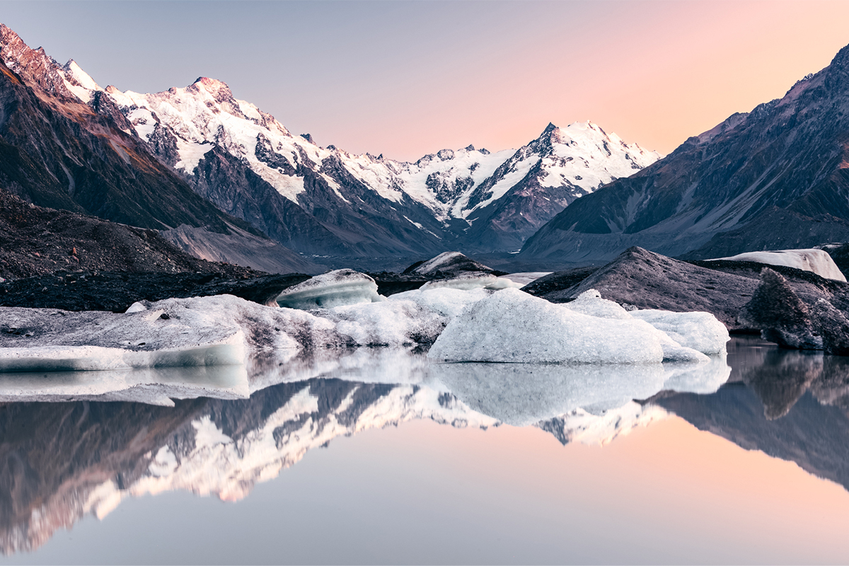 Snow capped mountain with iceberg on the lake